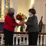 Choir member Barbara Carroll presents a bouquet to Chris on behalf of St. Gregory's Choir.