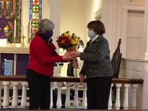 Choir member Barbara Carroll presents a bouquet to Chris on behalf of St. Gregory's Choir.