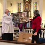 Chris and husband Jamie Green view framed photos 
from her tenure 
at Christ Church.
