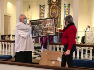 Chris and husband Jamie Green view framed photos 
from her tenure 
at Christ Church.